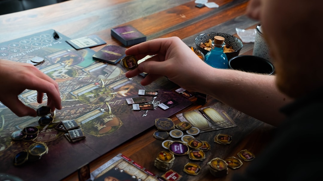 A man holds up a game token.